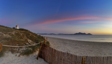 Picturesque Playa del Muro beach with sand dunes and a view of the historic maritime observation