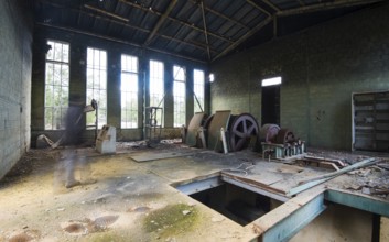 Interior of a deserted abandoned factory with human shade walking