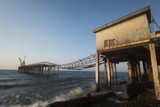 Seascape with old deserted industrial jetty during sunset at Karavostasi area near Leuka in Cyprus