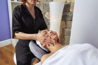 Head neck and facial massage woman with physiotherapist indoor