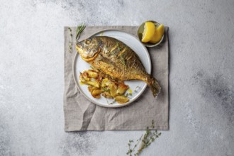 Food, Grilled sea bream or dorada on gray plate. Gray background