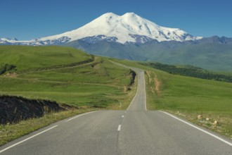 Road leading to mount Elbrus with green meadows at summer. North Caucasus, Russia, Europe