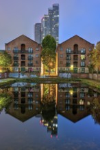 Old buildings and modern skyscrapers at night, seen in Castelfield, Manchester