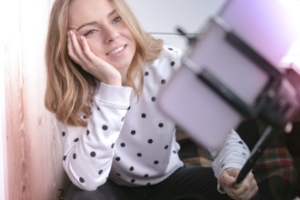 Blogging. Blonde girl blogger Technology internet and happiness concept. Young woman funny girl