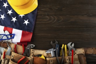 Tools hardhat toolbelt and us flag on wooden background labor day banner mockup
