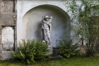 Shepherd carrying a sheep, sculpture in a cemetery, Jakobifriedhof, Leoben, Styria, Austria, Europe