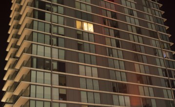 Single lit window in a modern apartment