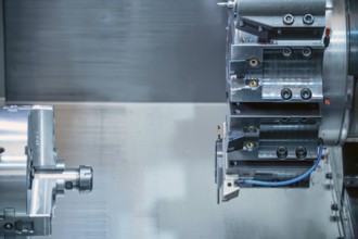 The CNC lathe machine forming cutting the metal parts. hi-technology metal working by CNC turning