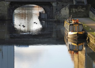 An old traditional narrow boat moored on the canal near brighouse basin in west yorkshire with