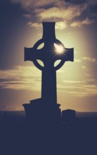 Vintage Style Image Of Sun Glinting Through A Celtic Cross Gravestone