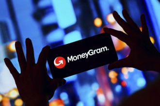 In this photo illustration, the MoneyGram logo is displayed on a smartphone screen