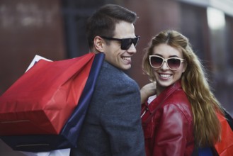 Picture showing young couple shopping in the city. Portrait of a couple with shopping bags in the