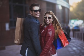 Picture showing young couple shopping in the city. Portrait of a couple with shopping bags in the