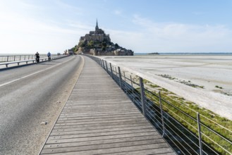 Mont Saint Michel, France, July 25, 2018: View of Mont Saint-Michel against sky. Cyclists on the