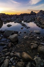 This is a color landscape photo of a vivid sunset over the Pacific Ocean