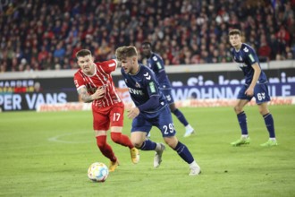 Running duel against# Lukas Kübler (Freiburg) and Jan Thielmann (1. FC Köln) at the match of the