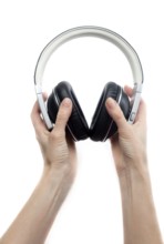 Leather earphones in female hands. Isolate on white