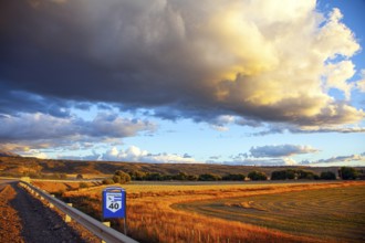 The endless Argentinean prairie and the famous Ruta 40 dirt road. A gigantic scenic thundercloud