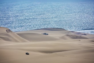Gorgeous and dangerous jeep - safari through the huge sand dunes on the ocean shore. Atlantic coast
