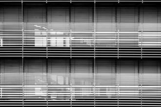 The modern façade of a chemical building and laboratory with highly light-reflecting metal blinds