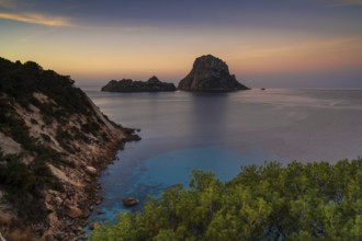 A view of the landmark Es Vedra island and rocks off the coast of Ibiza at sunrise