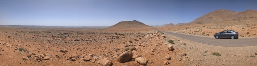 Panoramic desert landscape in the Souss-Massa region, a car driving on a road, Morocco, Africa