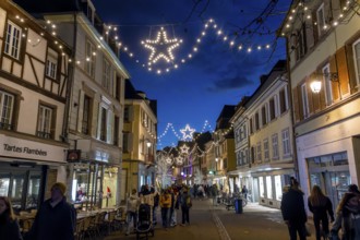 A street decorated for Christmas in the evening lighting atmosphere, Colmar, Alsace, Département