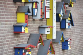 Many colorful birdhouses at the wall