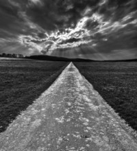 Bike path R1 with a dramatic cloudy sky, near Wesertal, Weser Uplands, Weserbergland, Hesse,