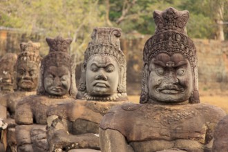 Balustrade with stone gods and demons on the bridge to the southern Tor tor of Angkor Thom