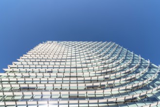 Madrid, Spain, May 1, 2019: Low angle view of Modern skyscraper in AZCA Financial District against