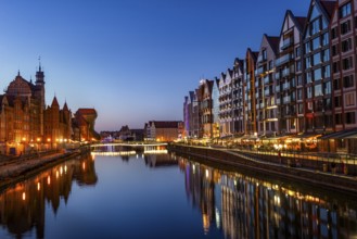 Illuminated embankment in the Old Town of Gdansk at sunset, Poland, Europe