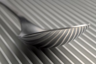 Abstract artistic picture of a spoon on a parallel grid structure