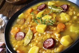 Rustic pea soup with bacon and sausage