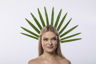 A creative portrait of a woman adorned with vibrant green leaves, symbolizing harmony between