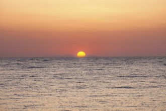 Sunrise over the sea, view from Kamari, island of Santorini, Cyclades, Greece, Europe