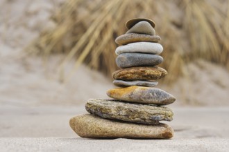 Stone pyramid on the beach at Zingst. Stones stacked on top of each other by the sea
