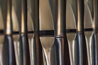 Close-up of lead organ pipes standing in a row in a church