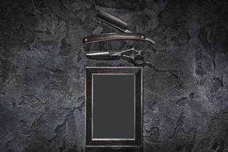 Black Stright Razor Scissors And Empty Frame In Barbershop Concept On Stone Slate Background