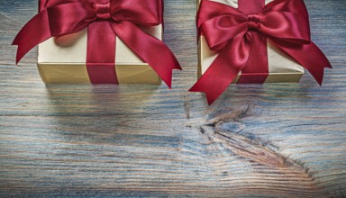 Gift boxes with tied knots on vintage wooden board celebration concept