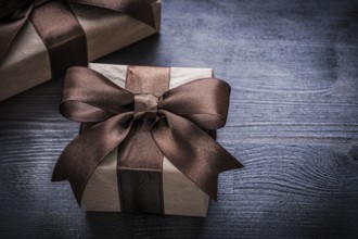 Present boxes with brown tied ribbons on vintage wooden surface