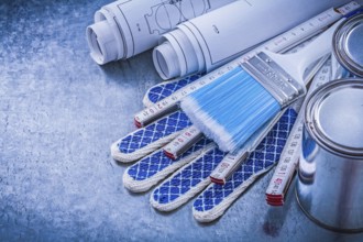 Composition of paint brushes cans wooden meter blueprints protective gloves