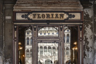Historic façade of the famous Caffè Florian with reflective windows, Piazza San Marco, symbolic