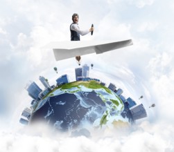 Pilot in leather helmet and goggles driving paper plane in cloudy blue sky. Funny man flying in