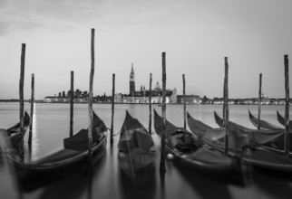 Moving Gondolas on Venice waterfront, San Giorgio Maggiore on the background