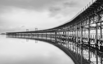 A black and white long exposure view of the historic Rio Tinto pier in Huelva