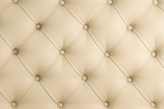 Beige soft tapestry pattern background with symmetrical buttons on the corners of diamonds. Soft