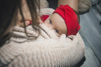 Loving Mother Cuddling Sleeping Newborn Baby daughter Over Shoulder
