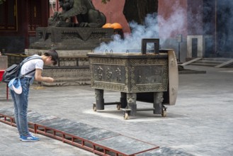 Beijing, China, June 8 2018 : Religious man praying at the Lama temple which is the biggest Tibetan