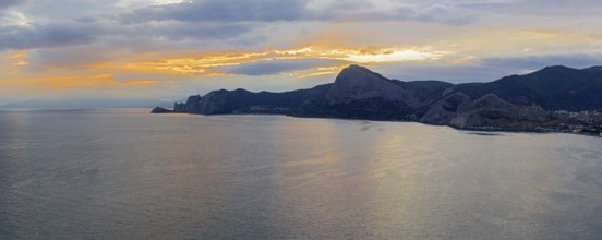 Sunset on the Black Sea coast of Crimea. View from the top of Cape Alchak to the west, towards